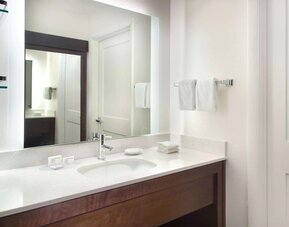 Private guest bathroom with shower and free toiletries at Sonesta ES Suites Raleigh Cary 
