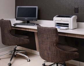 Business center with computer, printer and comfortable seating at Sonesta ES Suites Dallas Medical Market Center.