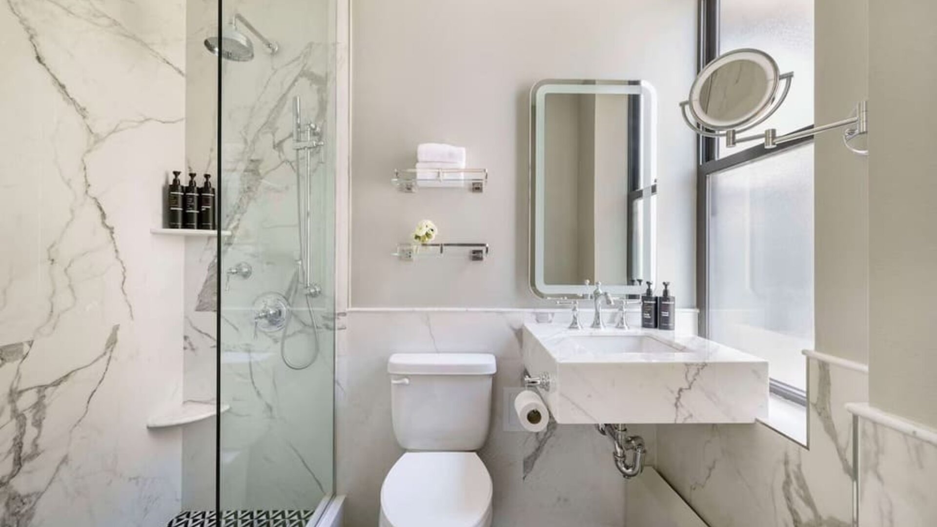 Private guest bathroom with shower at The Benjamin Royal Sonesta New York.
