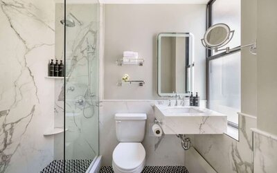 Private guest bathroom with shower at The Benjamin Royal Sonesta New York.