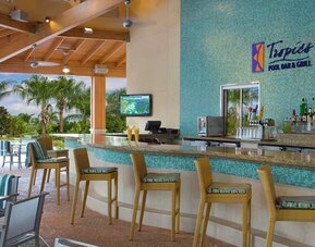 Beautiful and relaxing outdoor bar and restaurant by the pool at Hilton Orlando.