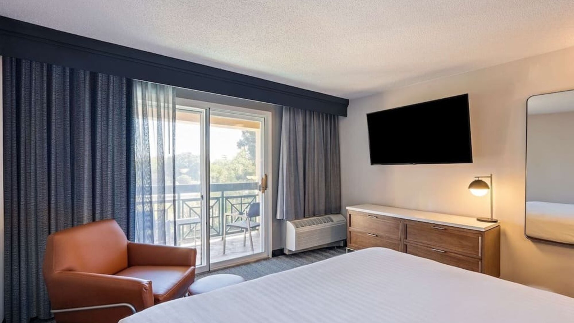 Bright and spacious day use room with balcony and work desk at Sonesta Select Pleasant Hill.