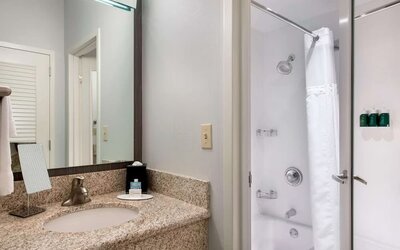 Private guest bathroom with shower and free toiletries at Sonesta Select Newport Middletown.