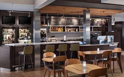 On-site coffee shop with seating area, perfect for coworking at Sonesta Select Newport Middletown.