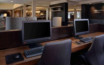 Business center with computers, printer and ergonomic chair at Sonesta Select Kansas City South Overland Park.
