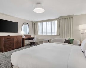 Day use room with work desk and sofa at Hilton Crystal City At Washington Reagan National Airport.