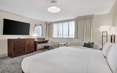 Day use room with work desk and sofa at Hilton Crystal City At Washington Reagan National Airport.