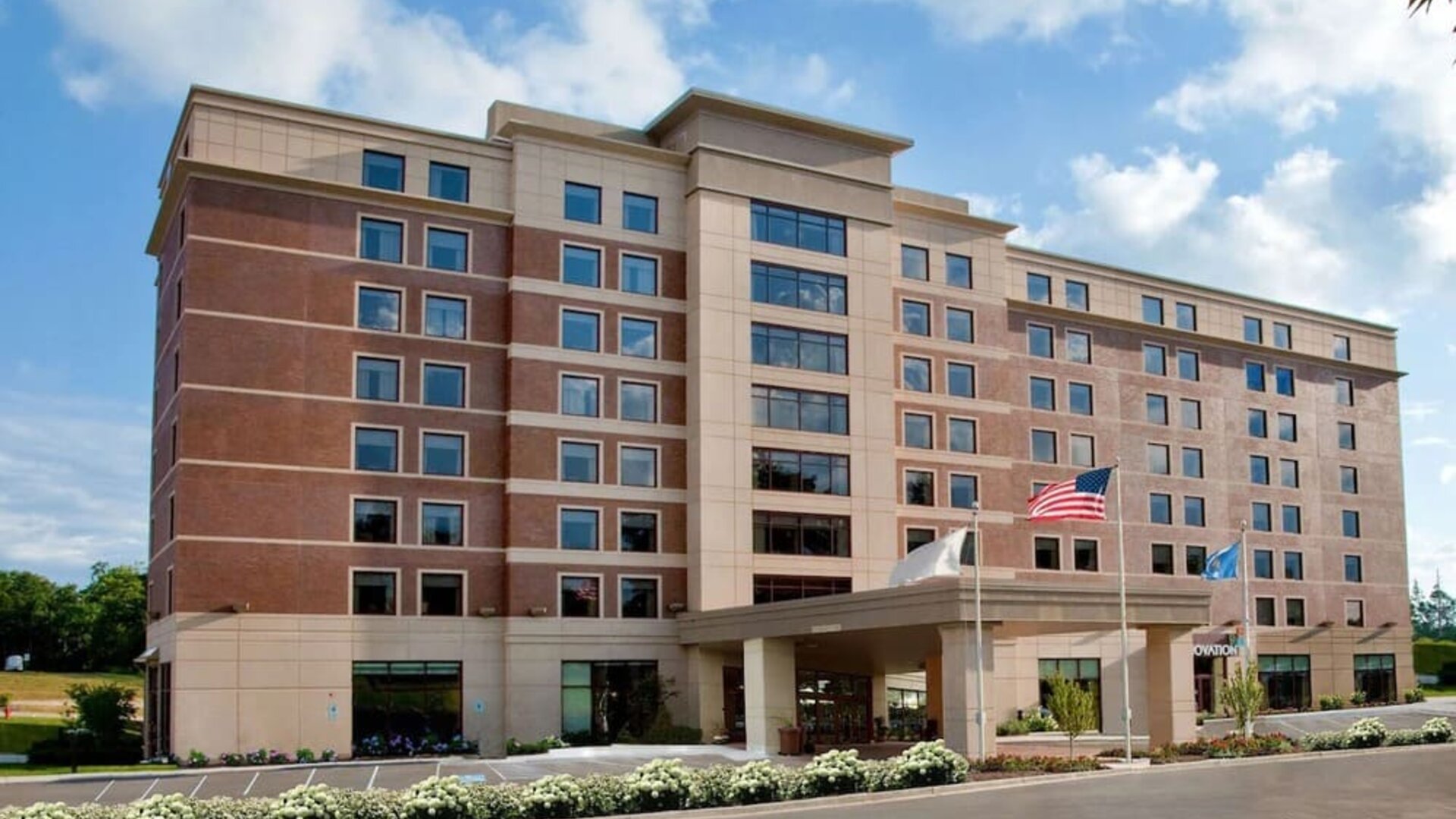 Hotel exterior and parking area at Sonesta Milwaukee West Wauwatosa.