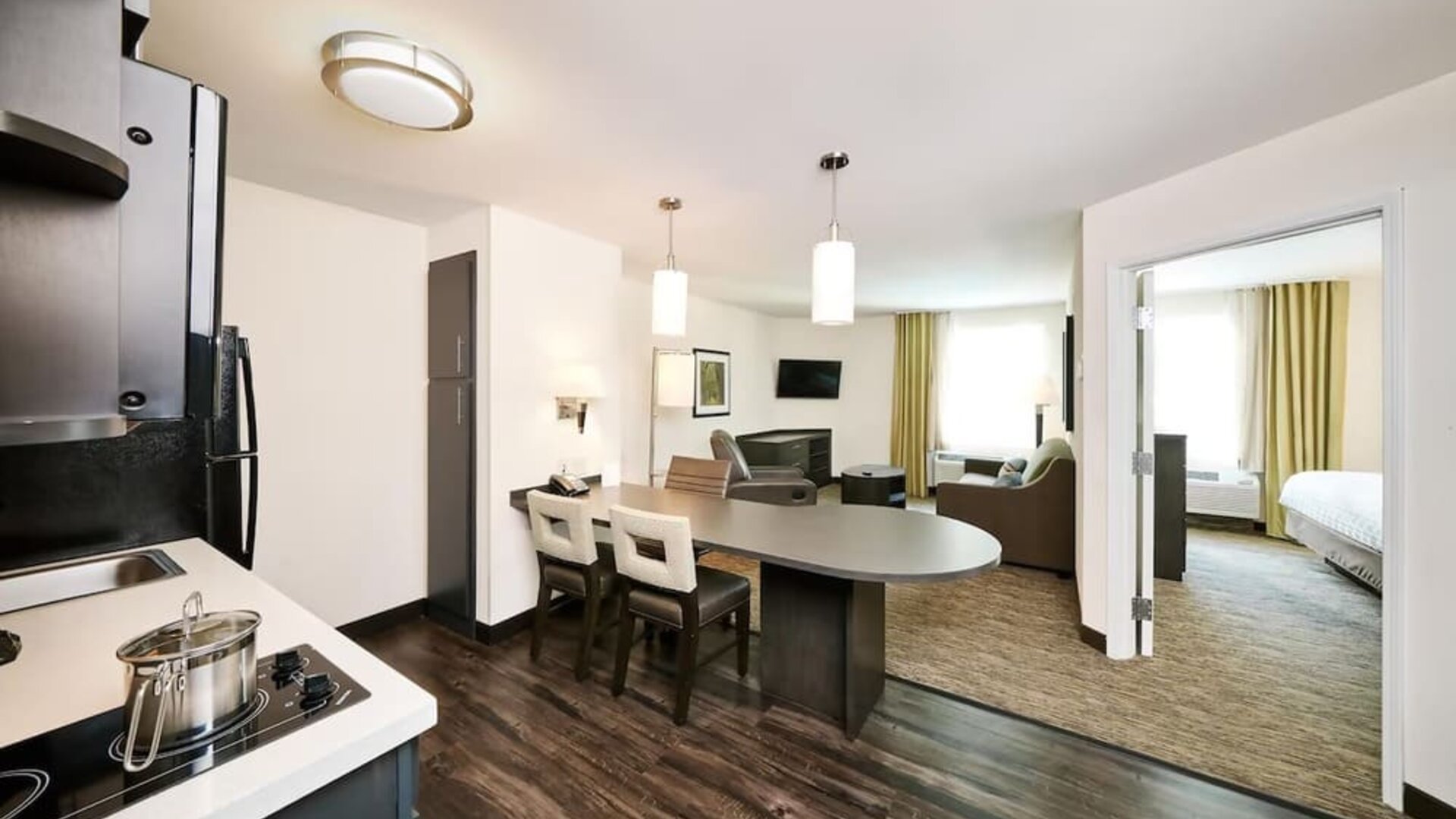 Day use suite with in-room kitchen, living area and private bathroom at Sonesta Simply Suites Plano Frisco.