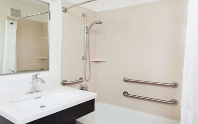 Private guest bathroom with shower at Sonesta Simply Suites Plano Frisco.