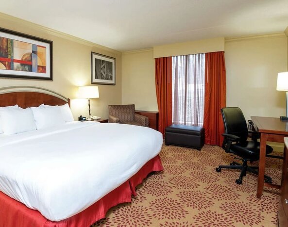 Work desk and sofa in a king bedroom at DoubleTree By Hilton Grand Rapids Airport.