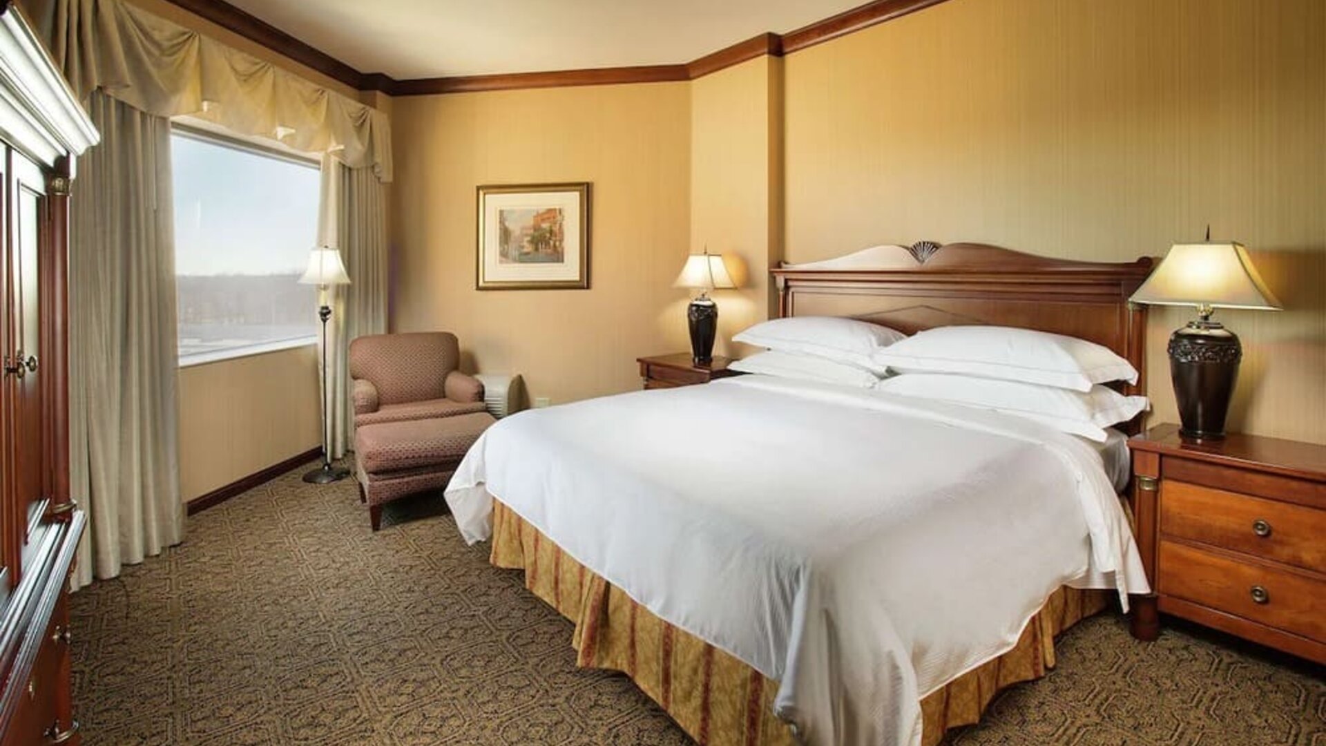 Bright and comfortable hotel room with king size bed and window at DoubleTree By Hilton Lisle-Naperville.