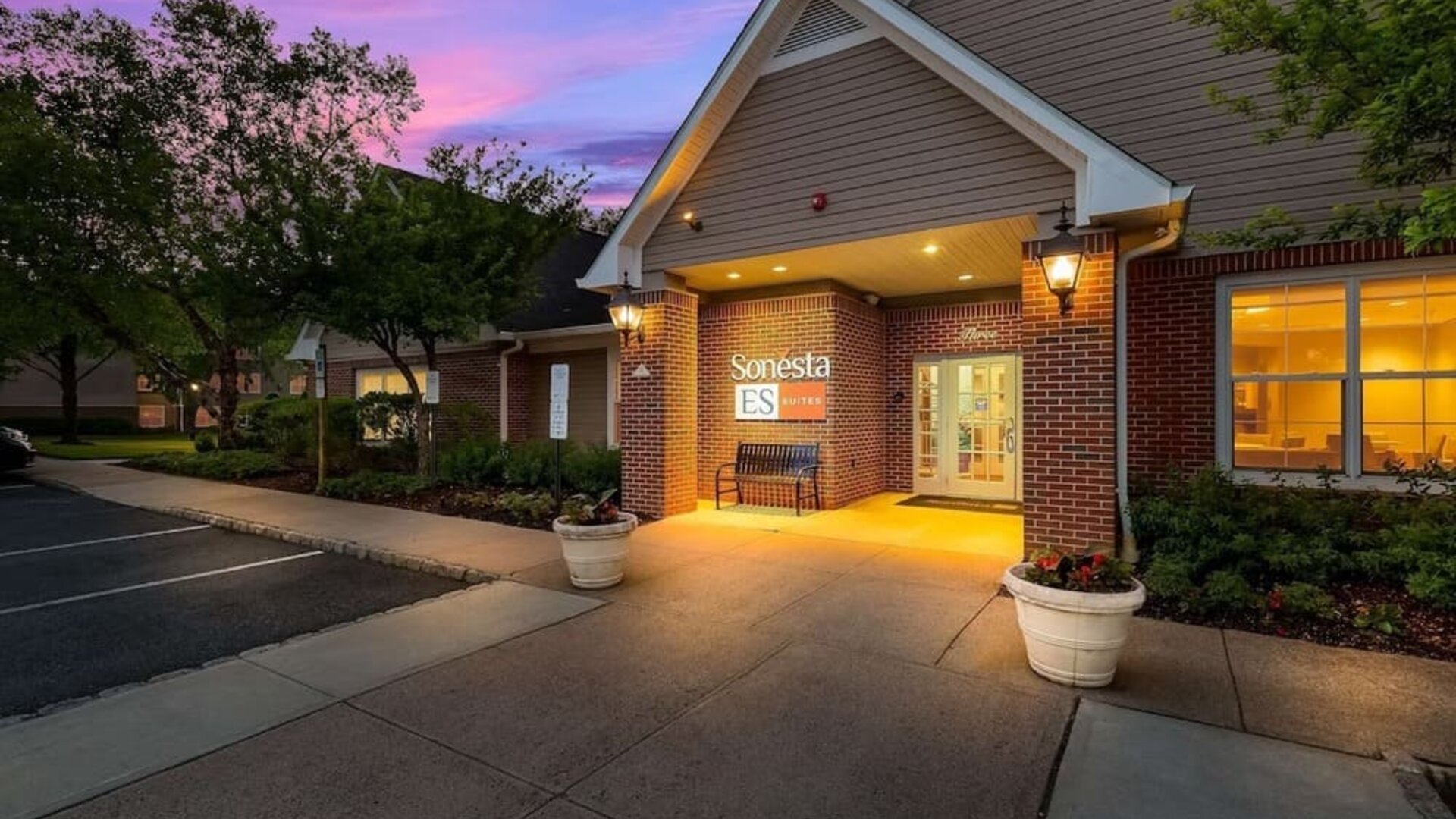 Hotel exterior and parking area at Sonesta ES Suites Parsippany Morris Plains.