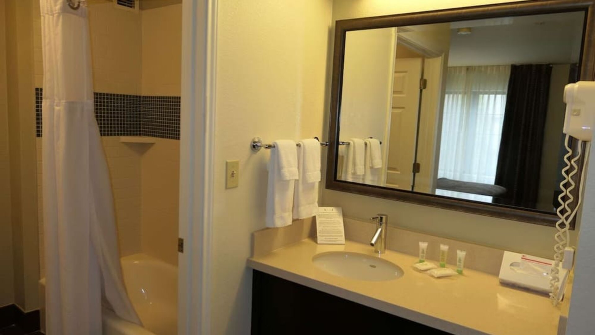 Private guest bathroom with combined shower and tub at Sonesta ES Suites Portland Vancouver 41st Street.