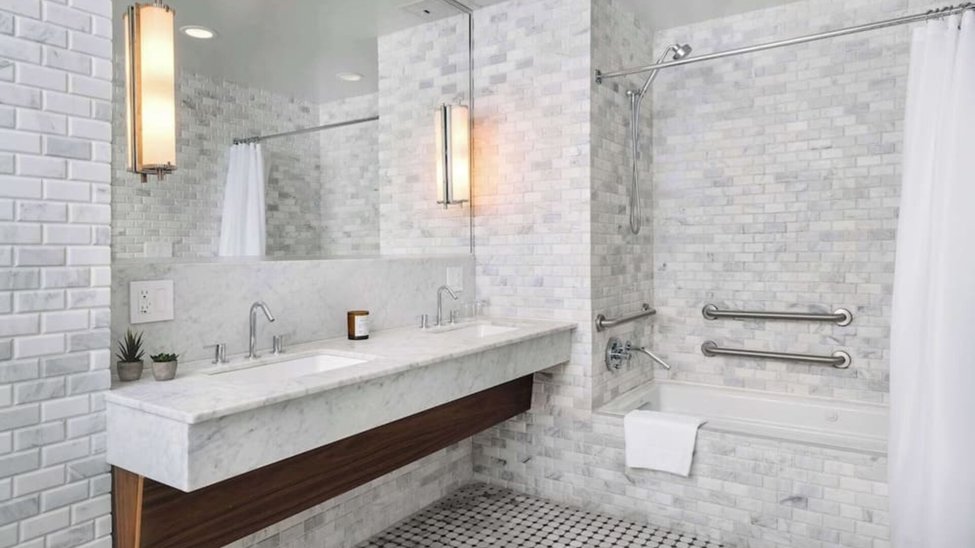 Private guest bathroom with combined shower and tub at Nautilus Sonesta Miami Beach.