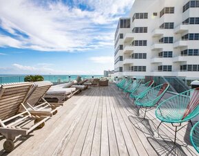 Terrace with lounge seating at Nautilus Sonesta Miami Beach.