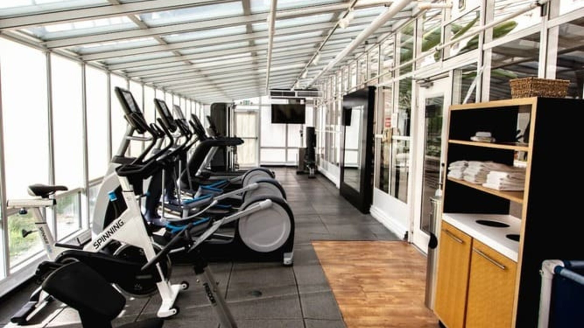 Fitness center with natural light at Embassy Suites By Hilton San Francisco Airport Waterfront.