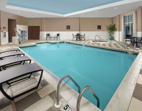 Refreshing indoor pool with loungers at Embassy Suites By Hilton Birmingham.