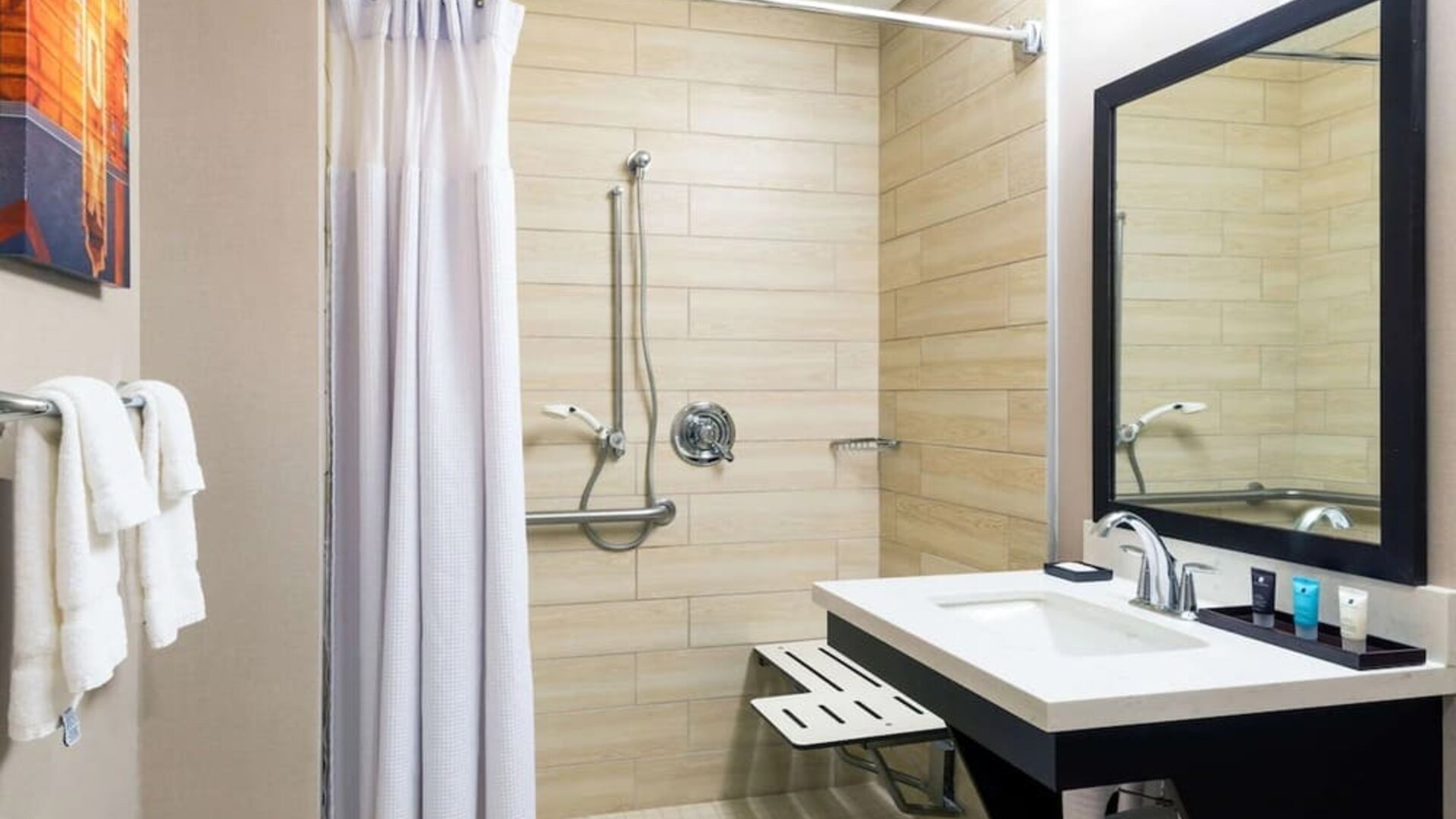 Accessible private guest bathroom with shower at Sonesta Atlanta Airport North.
