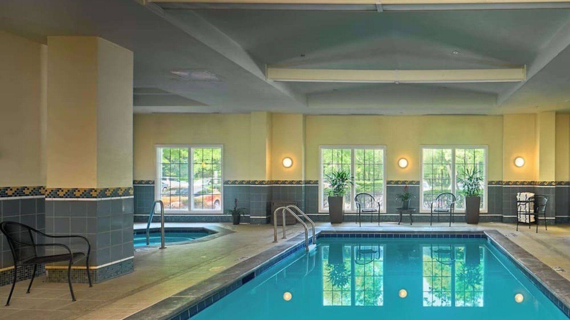 Indoor pool with lounge chairs at Sonesta Atlanta Airport South.