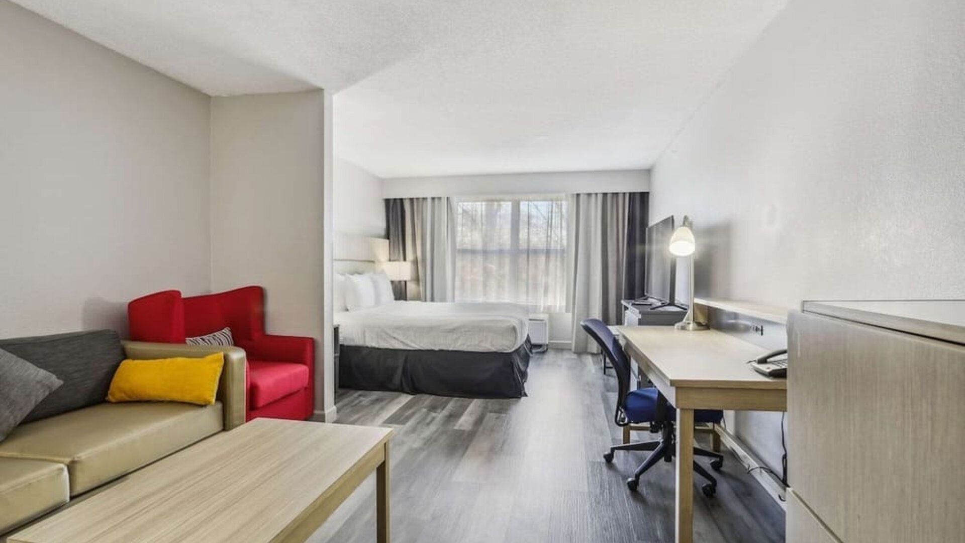 Day use room with work desk and living area at Country Inn & Suites By Radisson, Chicago O'Hare South.