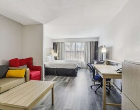 Day use room with work desk and living area at Country Inn & Suites By Radisson, Chicago O'Hare South.