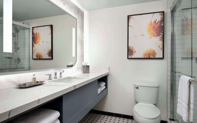 Private guest bathroom with shower and free toiletries at Sonesta Los Angeles Airport LAX.