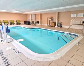 Relaxing indoor heated pool with lounge chairs at Holiday Inn Belcamp - Aberdeen Area.