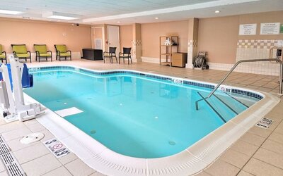 Relaxing indoor heated pool with lounge chairs at Holiday Inn Belcamp - Aberdeen Area.