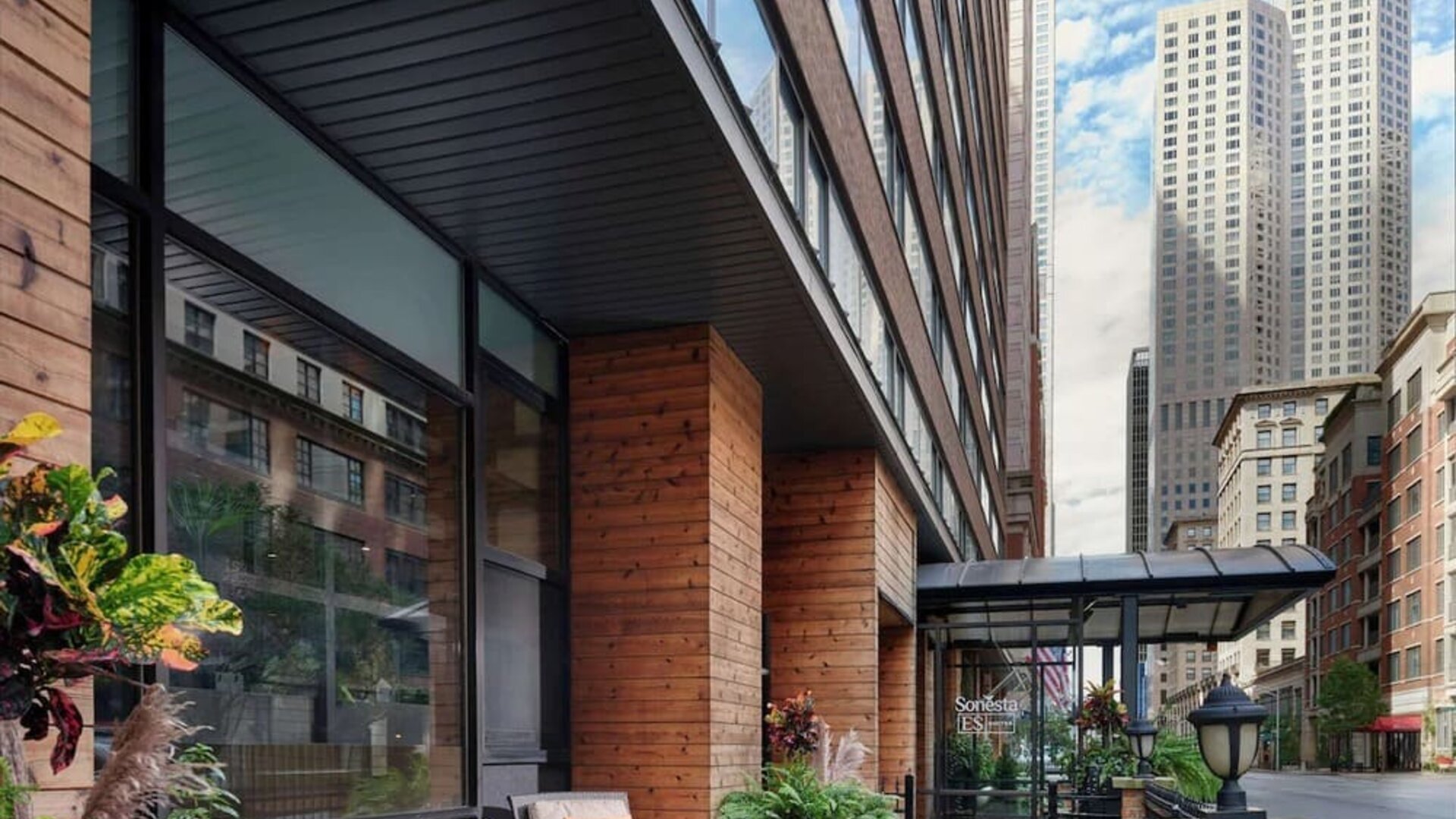 Hotel entrance and terrace with lounge seating at Sonesta ES Suites Chicago Downtown Magnificent Mile - Medical.