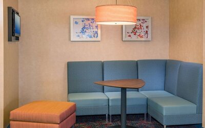 Lobby workspace with comfortable seating at Sonesta ES Suites Charlottesville University.