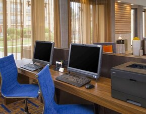 Business center with computers, printer and ergonomic chairs at Sonesta Select Charlotte University Research Park.