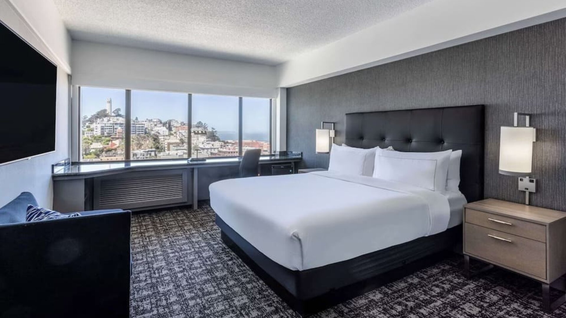 Day use room with sofa and work desk overlooking the city at Hilton San Francisco Financial District.