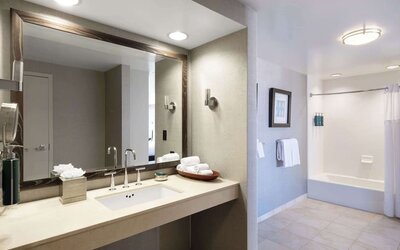 Guest bathroom with shower and tub at Hilton San Francisco Financial District.