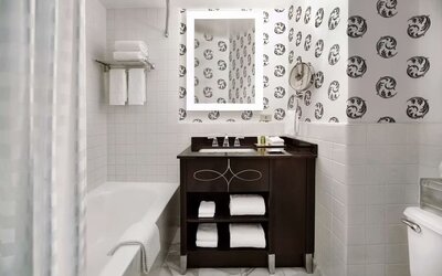 Guest bathroom with shower and tub at Palmer House A Hilton Hotel.