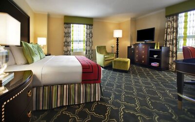Spacious king suite with work desk and lounger at Palmer House A Hilton Hotel.
