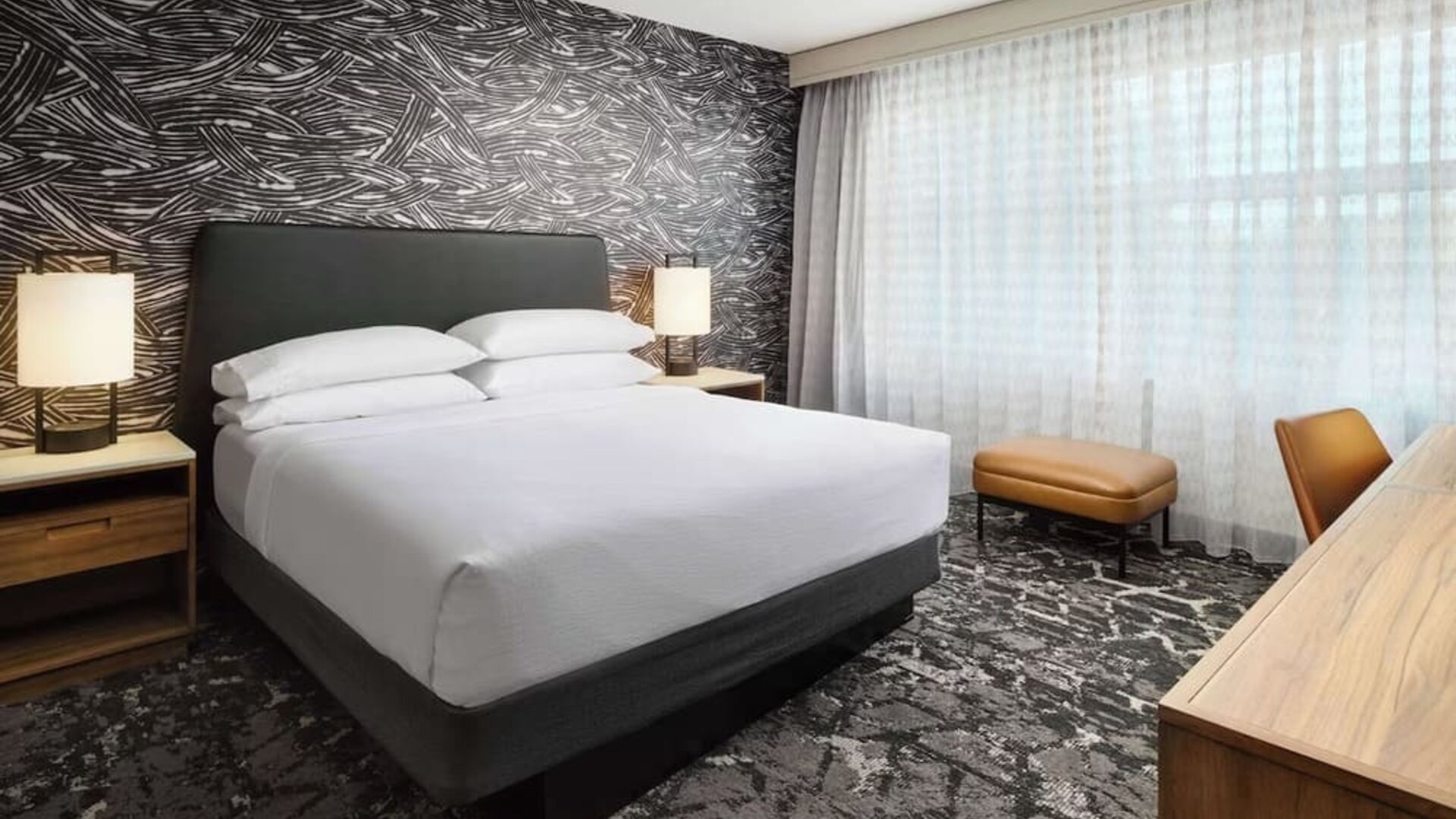 Day use room with work desk and natural light at Embassy Suites By Hilton Hampton Convention Center.