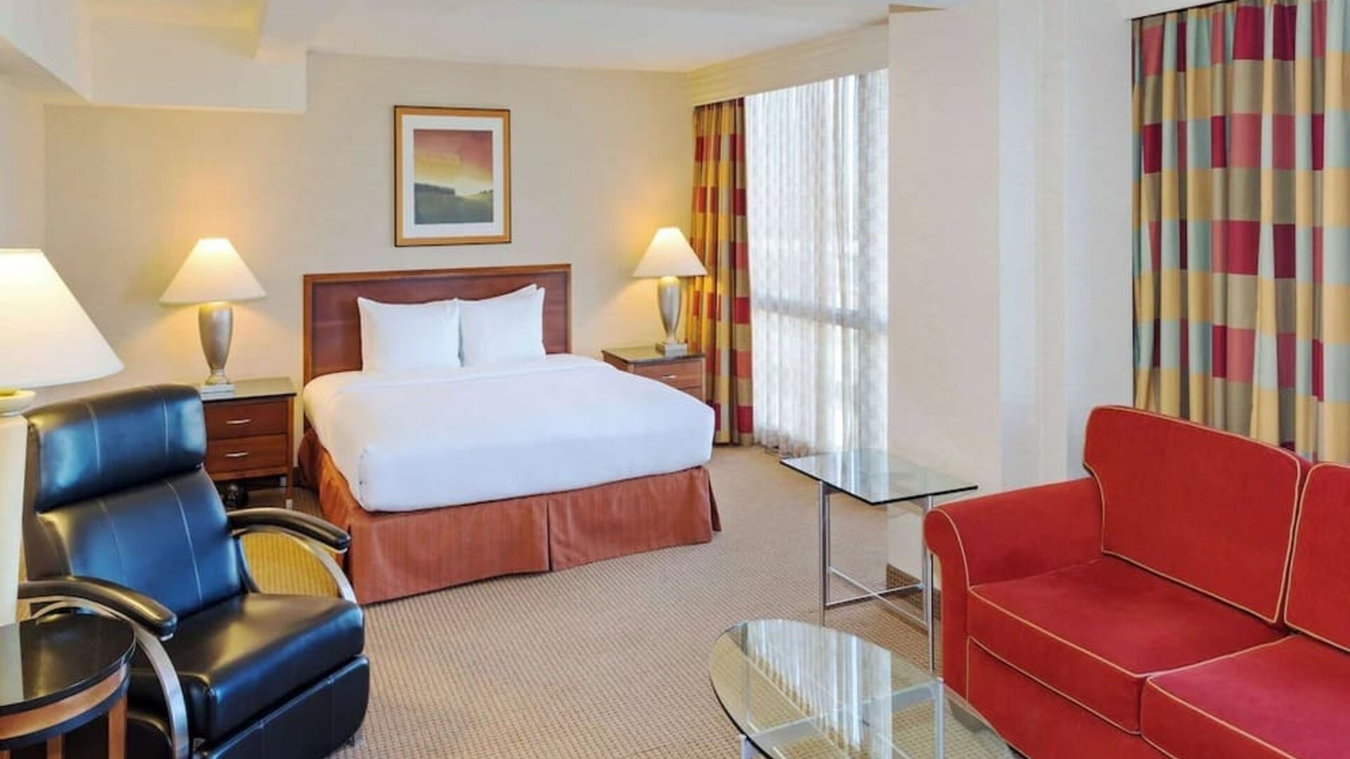 King size suite with sound proofed windows and lounger at Hilton Chicago O'Hare Airport.