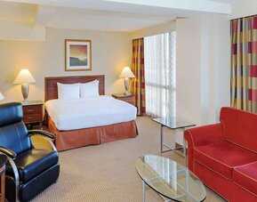 King size suite with sound proofed windows and lounger at Hilton Chicago O'Hare Airport.