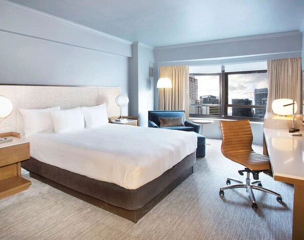 Day use room with work desk and natural light at New York Hilton Midtown.