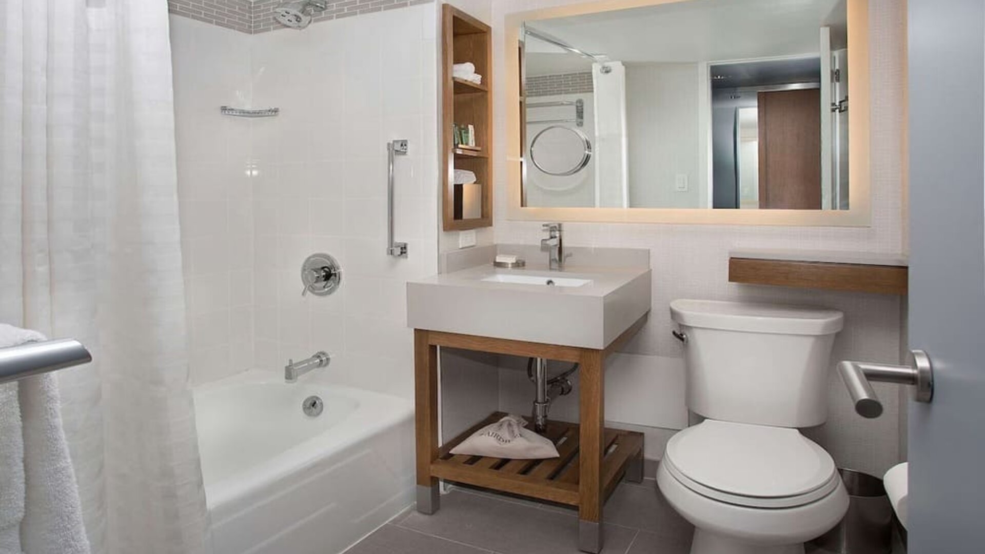 Guest bathroom with shower and tub at New York Hilton Midtown.