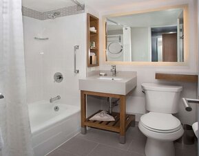 Guest bathroom with shower and tub at New York Hilton Midtown.