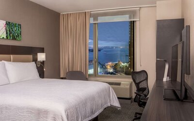 King bedroom with work station and city view at Hilton Garden Inn NYC Financial Center/Manhattan Downtown.
