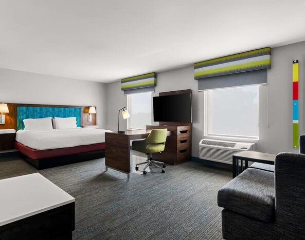 Spacious hotel suite with king size bed and working station at Hampton Inn & Suites Schererville.