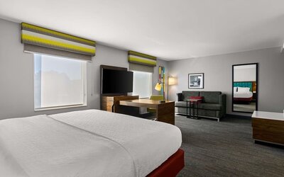 Spacious hotel suite with king size bed and working station at Hampton Inn & Suites Schererville.
