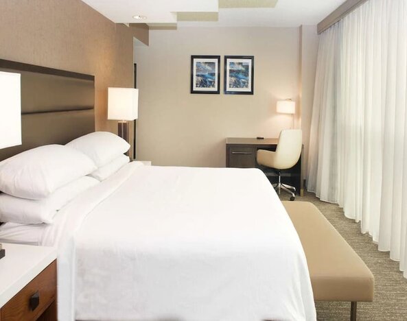 Spacious delux king room with work desk and natural light at Embassy Suites By Hilton Seattle-North-Lynnwood.