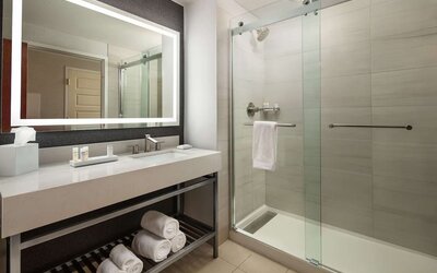 Guest bathroom with shower at Hilton Charlotte Airport.
