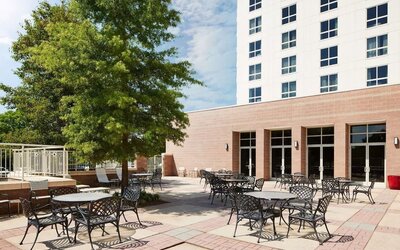 Outdoor seats available in the courtyard of the Hilton Charlotte Airport.

