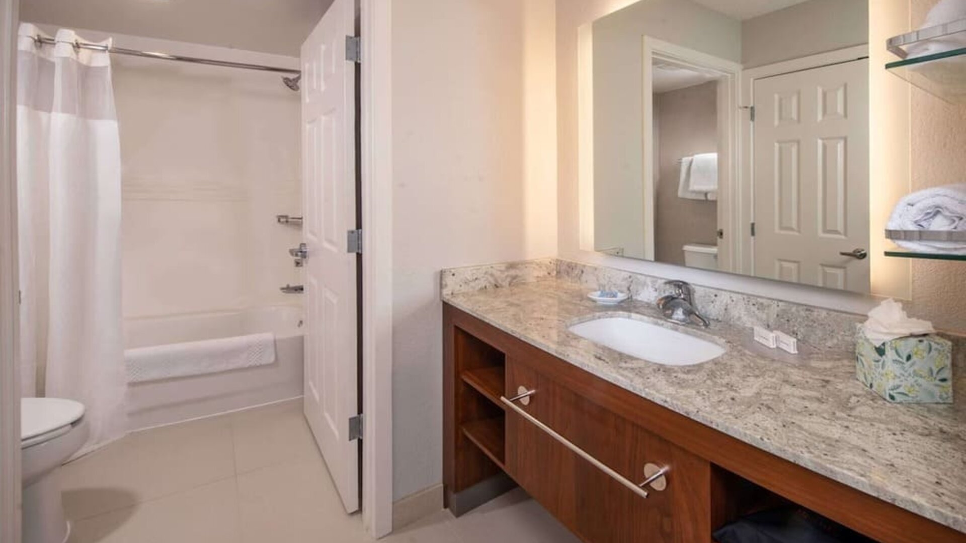 Private guest bathroom with combined shower and tub at Sonesta ES Suites Baltimore BWI Airport.