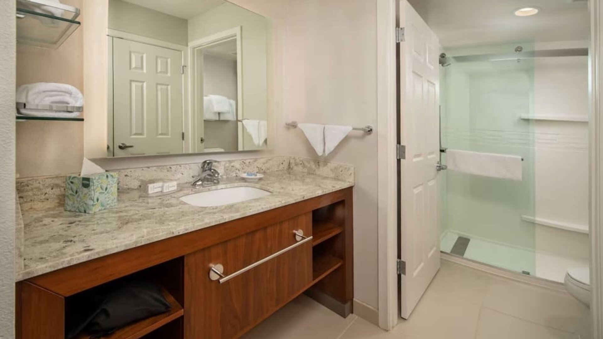 Private guest bathroom with shower and free toiletries at Sonesta ES Suites Baltimore BWI Airport.
